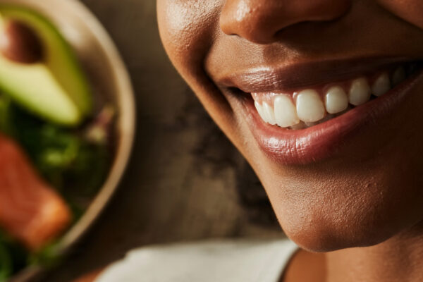 A healthy woman enjoying a diet rich in healthy fats for glowing skin.