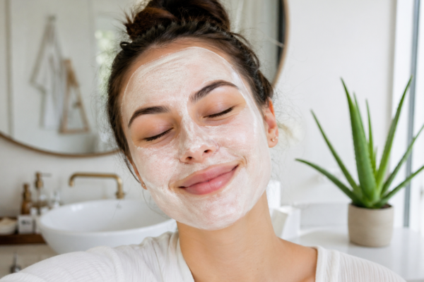 A relaxed woman enjoying a soothing face mask on her skin after exfoliation.